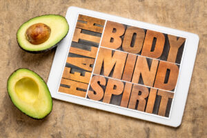 Avocado with mind, body, spirit text